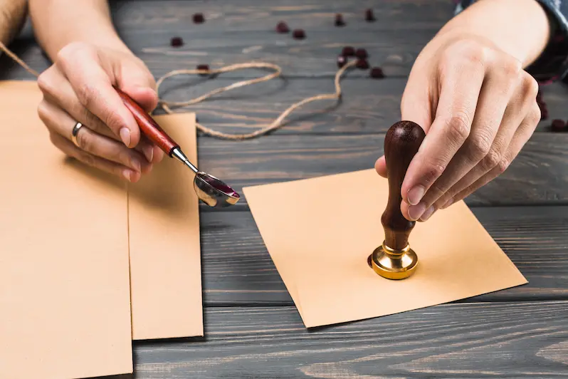 من نحن 1 woman s hand sealing envelope with stamp
